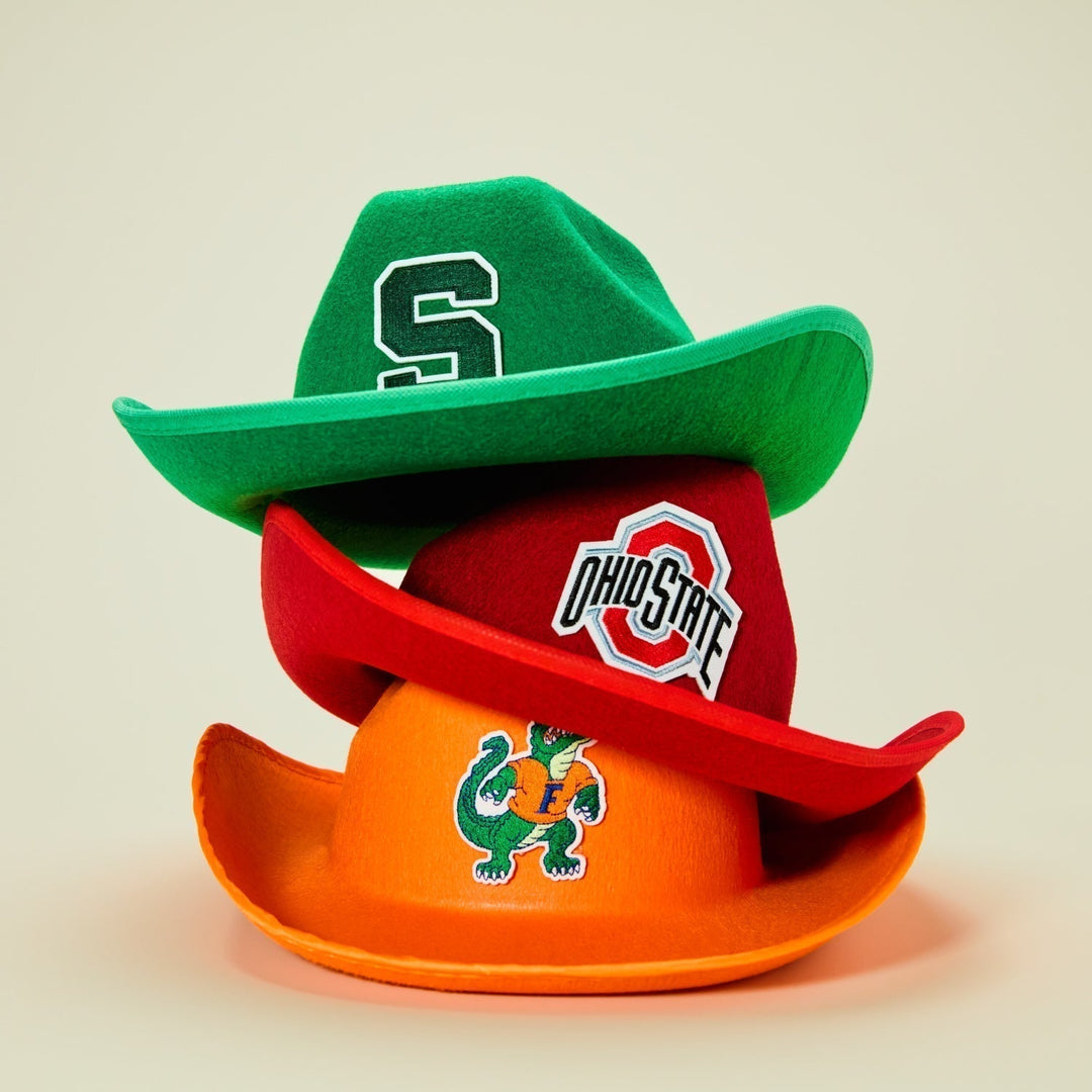 Three felt cowboy hats stacked on top of each other, green on top, red in middle and orange on bottom